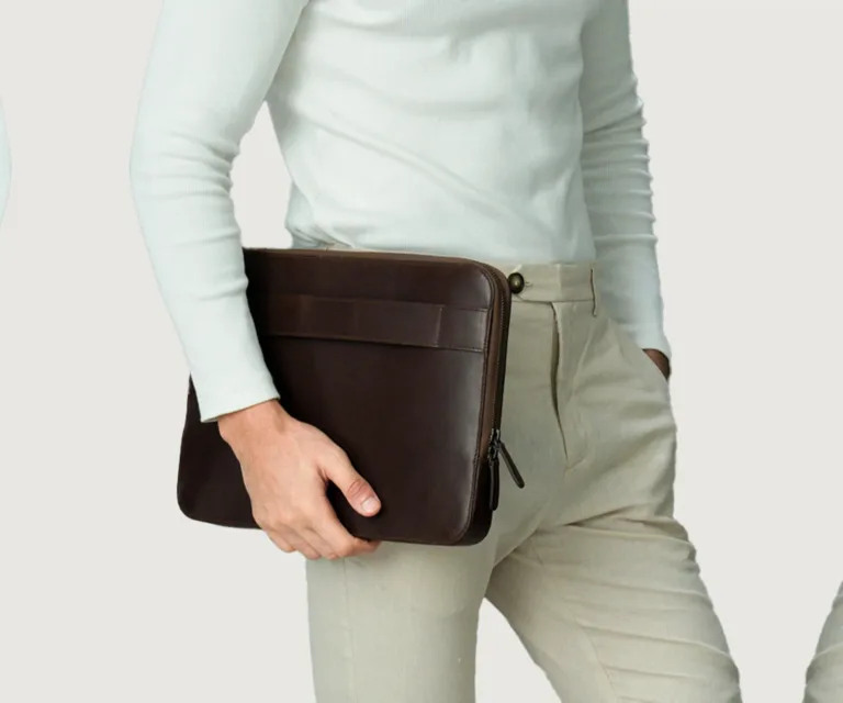 The Baxter Vintage Brown Leather Laptop Sleeve Luxury Handcrafted Leather Bag — Scale & Carrying Perspective Presentation